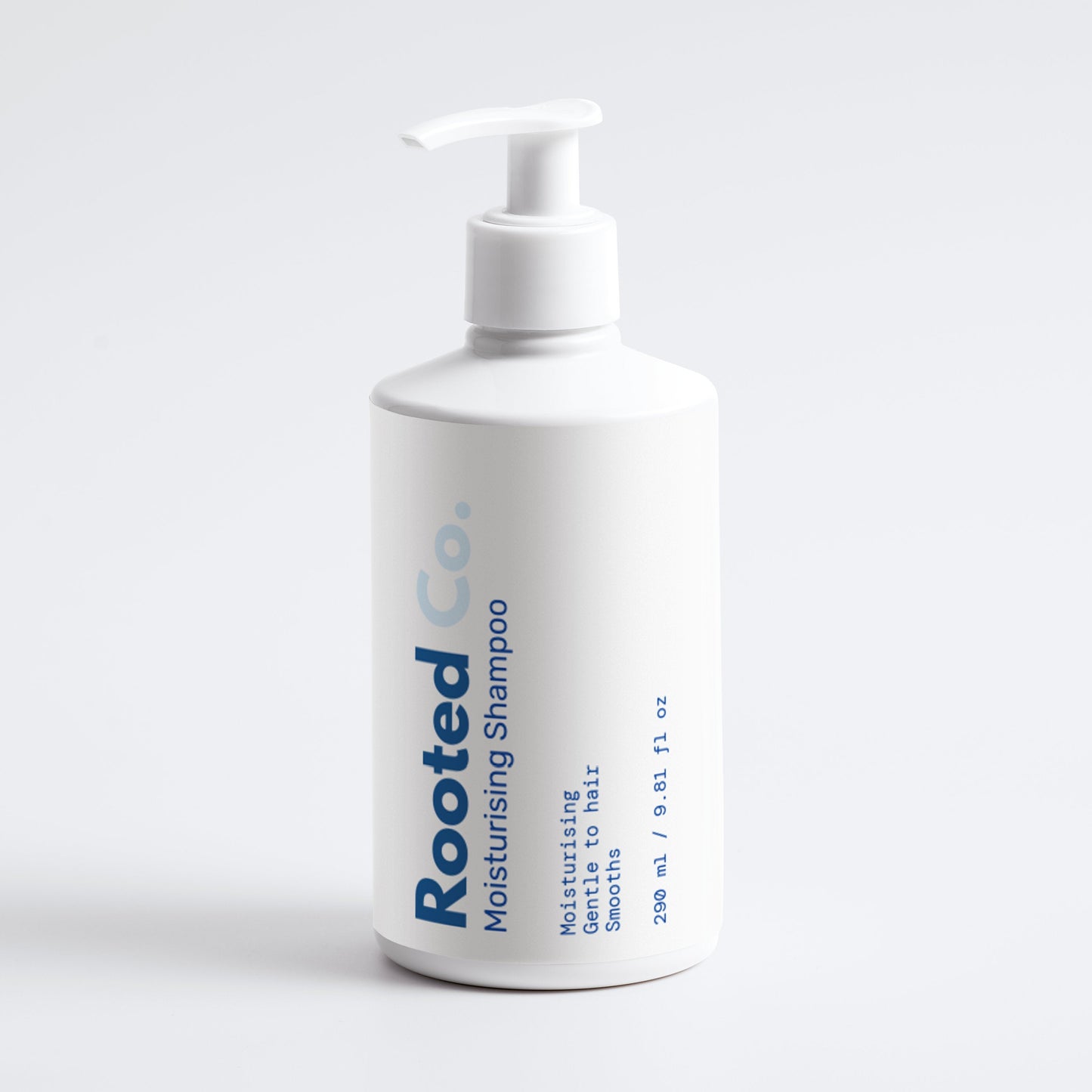 White bottle of Rooted Co. moisturizing shampoo on a light gray background