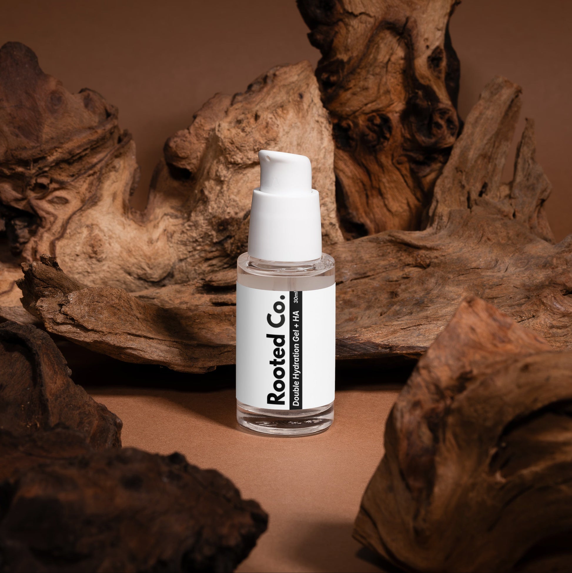 Skincare bottle labeled 'Rooted Co.' on a brown background with natural wood elements.