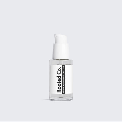Skincare serum bottle with white label on a light gray background