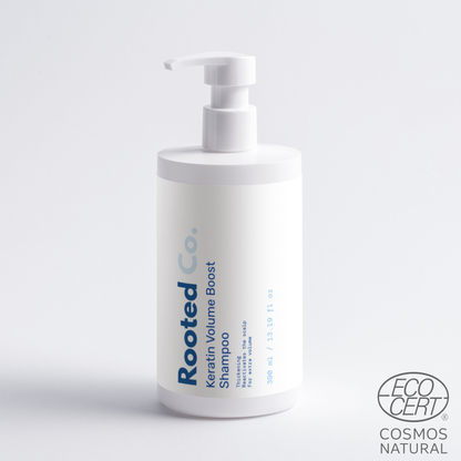 Shampoo bottle labeled 'Rooted Co.' on a white background