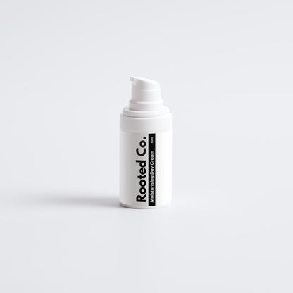 White bottle with 'Rooted Co.' label on a light gray background