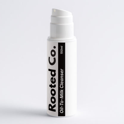 White skincare product bottle with 'Rooted Co.' branding on a light gray background