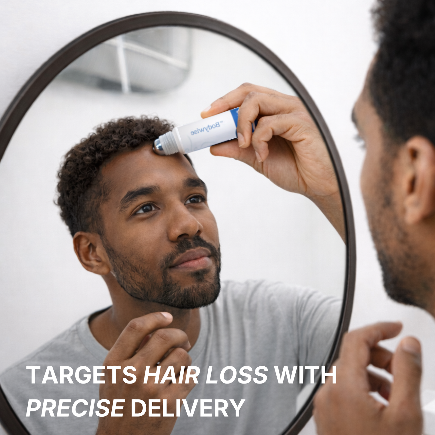 Man applying a hair care product to his head in front of a mirror.