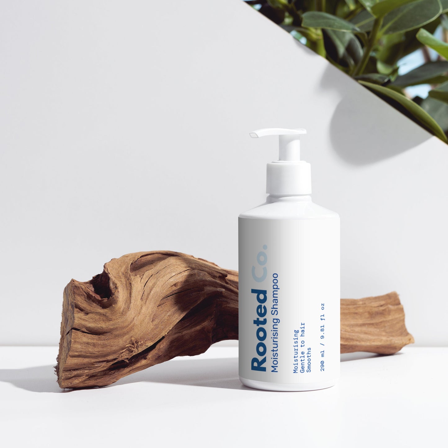 Aurevia bottle of sensitive skin facial and body cleanser on a white surface with a plant in the background.
